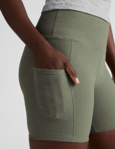 green high-waisted 5" inseam biker shorts  with pockets.